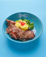 Roast steak with mashed potatoes and vegetables. Delicious bbq meat iwth mashed potatoes. Barbecue with sauce.