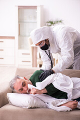 Fototapeta premium Young paramedic visiting old man at home