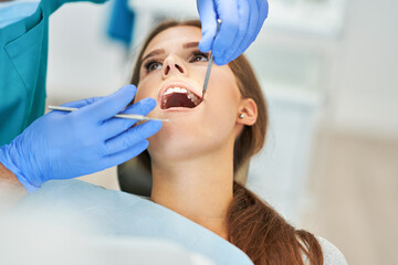 Fototapeta premium Male dentist and woman in dentist office