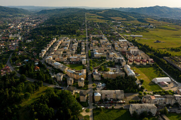 Obraz premium Aerial view of a straight street, crossing a whole neighbourhood and continuing further, in Campulung Muscel, Romania