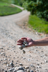 Stones falling from man hand.