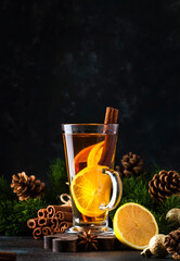 Christmas or New Year hot winter drink, spicy grog cocktail, punch or mulled wine with tea, lemon,...