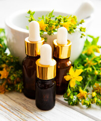 St johns wort oils, and  fresh herbs in a mortar