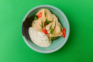 Ukrainian dish Vareniki, ukrainian dumplings, pierogi with sauce - traditional Ukrainian food.
