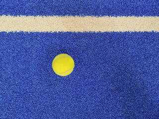 Padel's ball in a blue court background