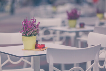 Restaurant exterior with flowers on the table at the city streets