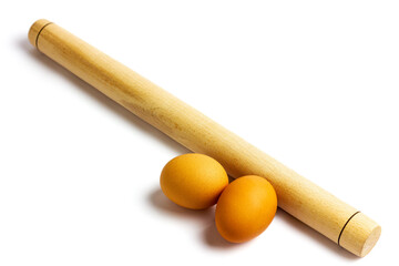 Rolling pin for dough and egg on a white background. Dough preparation.