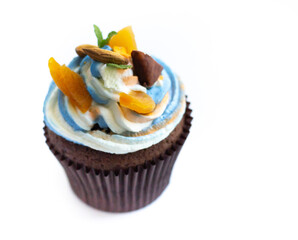Delicious fresh cupcake with cream of three colors on a white background