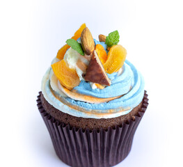 Delicious fresh cupcake with cream of three colors on a white background