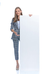 happy businesswoman holding and presenting empty board