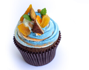 Delicious fresh cupcake with cream of three colors on a white background