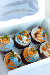Fresh tricolor cream cupcakes in a white package