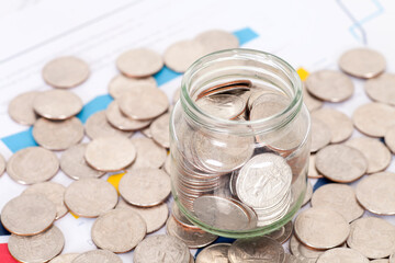 A lot of dollar coins on a glass bottle