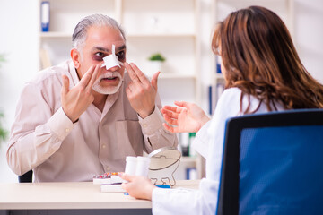 Old man visiting young female doctor for plastic surgery