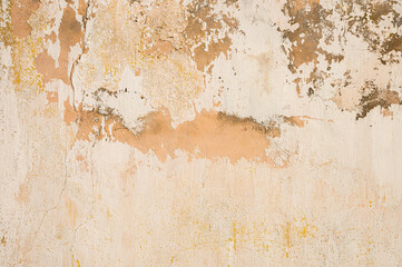 Grunge background of cracked cloud peeled putty wall in beige tones
