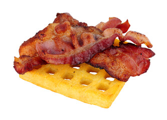 Streaky smoked bacon rashers on a grilled potato waffle isolated on a white background