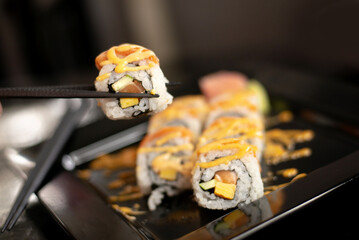 use chopsticks pick up japanese sushi roll