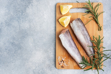 Raw hake fish carcass on a wooden chopping Board. top view Copy space