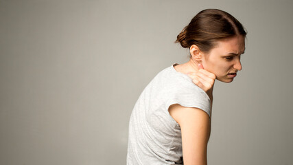 Obraz premium Tired woman feeling pain, massaging tense muscles
