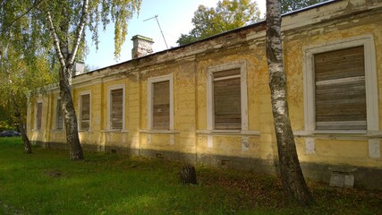 Old abandoned house in disrepair. Windows are filled with wooden planks instead of glass. Poverty, devastation, economic, financial and housing development crisis. Mortgage Interest rate risk concept.