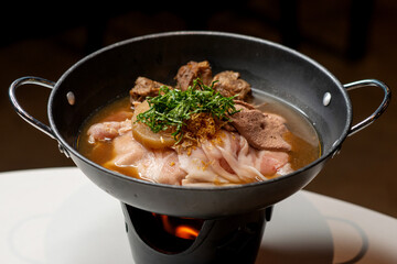 beef soup steaming in warm pan