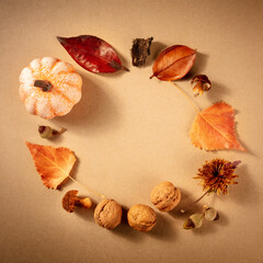 Square autumn background with fall leaves, a flat lay with copy space on a brown background