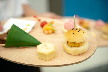 canapes finger food on wooden platter
