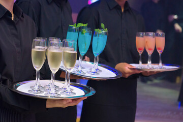 waitress are holding beverage tray for party guest