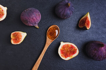 Fig jam in a wooden spoon and fresh figs