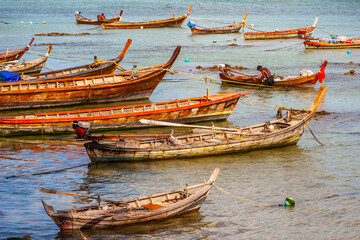Fototapeta na wymiar Beautiful landscape with traditional longtail boats, tropical sand beach. Traveling Andaman Sea, Thailand. Adventures and travel concept.