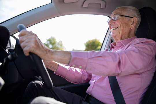 Smiling Senior Man Enjoying Driving Car