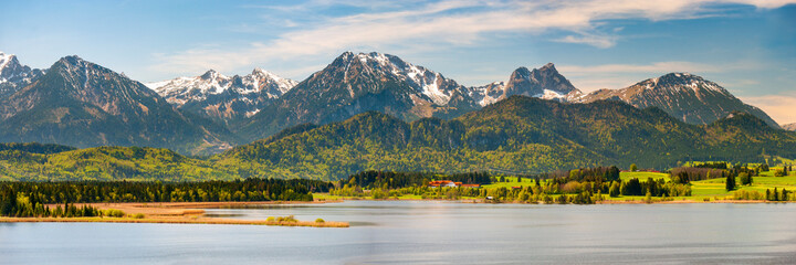panoramic landscape in Bavaria with mountain range and lake