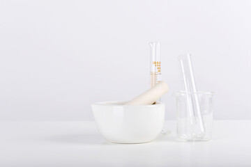 Group of scientific laboratory glassware and mortar with clear liquid solution, Research and development concept.
