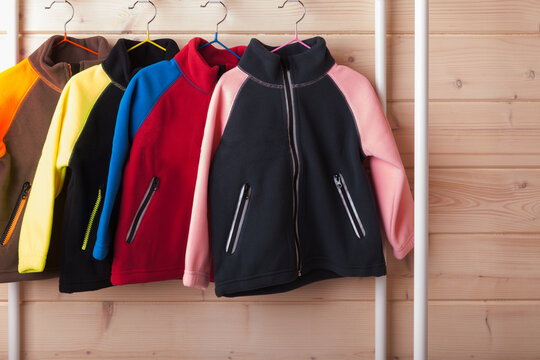 Colorful Fleece Jackets Are Hanging On Hangers