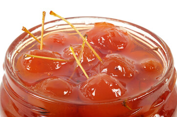  A top of a glass jar with a paradise apple jam inside. Isolated on a white background