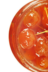  A top view of a detail of a glass jar with a paradise apple jam inside. Isolated on a white background