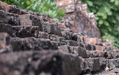 Close-up of Cracked concrete vintage brick wall background. Archaeological area. Pattern on the wall with space for text, Focus and blur.