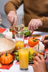 Cropped view of men eating tasty dinner during thanksgiving