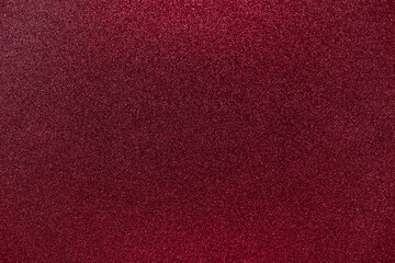 Dark red grainy background with small granules, Christmas grunge texture