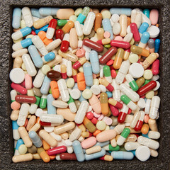 A lot of colorful medicines drugs and tablets in a box