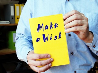 Business concept meaning Make A Wish with inscription on the piece of paper.