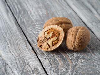 Walnut with shell on wooden background.