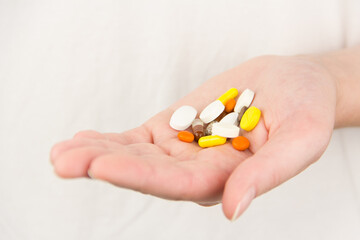 multicolored pills lie in hand