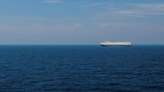 A large ship for transporting goods across the ocean. Rollers. Trailer vessels. Ro-Ro type vessel. A huge ship for transporting cars and equipment. Aerial  4K shot.