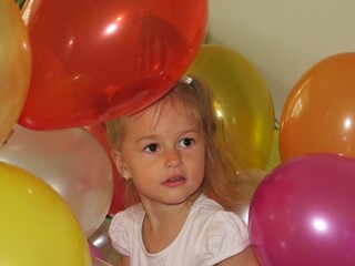 little girl playing with air balloons
