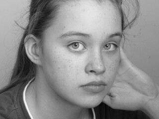 close up portrait of a serious and thoughtful girl in black and white