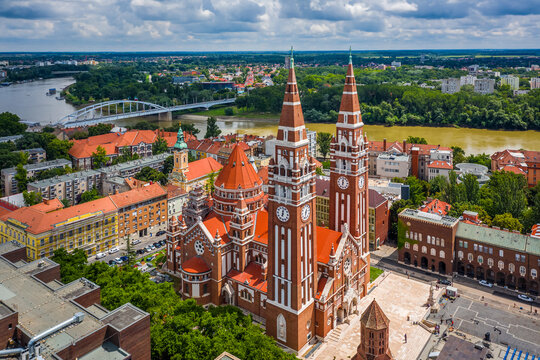 Szeged, Hungary - Aerial view of the Votive Church and Cathedral of Our Lady of Hungary (Szeged Dom) on a sunny summer day with Inner Town Bridge (Belvarosi hid) and blue sky and clouds