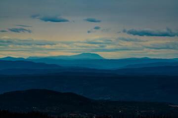 Mountains and hills clouded in a thin haze.