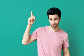 Fototapeta premium Handsome thoughtful man pointing his finger up