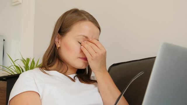 Home office woman portrait work on laptop computer take off glasses and massage tired eyes